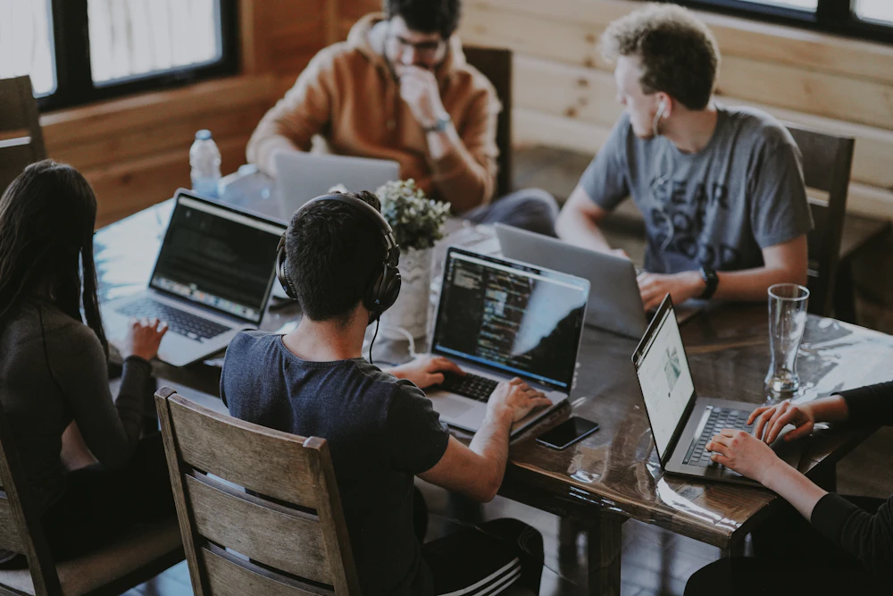 Team planning a website project together around a laptop